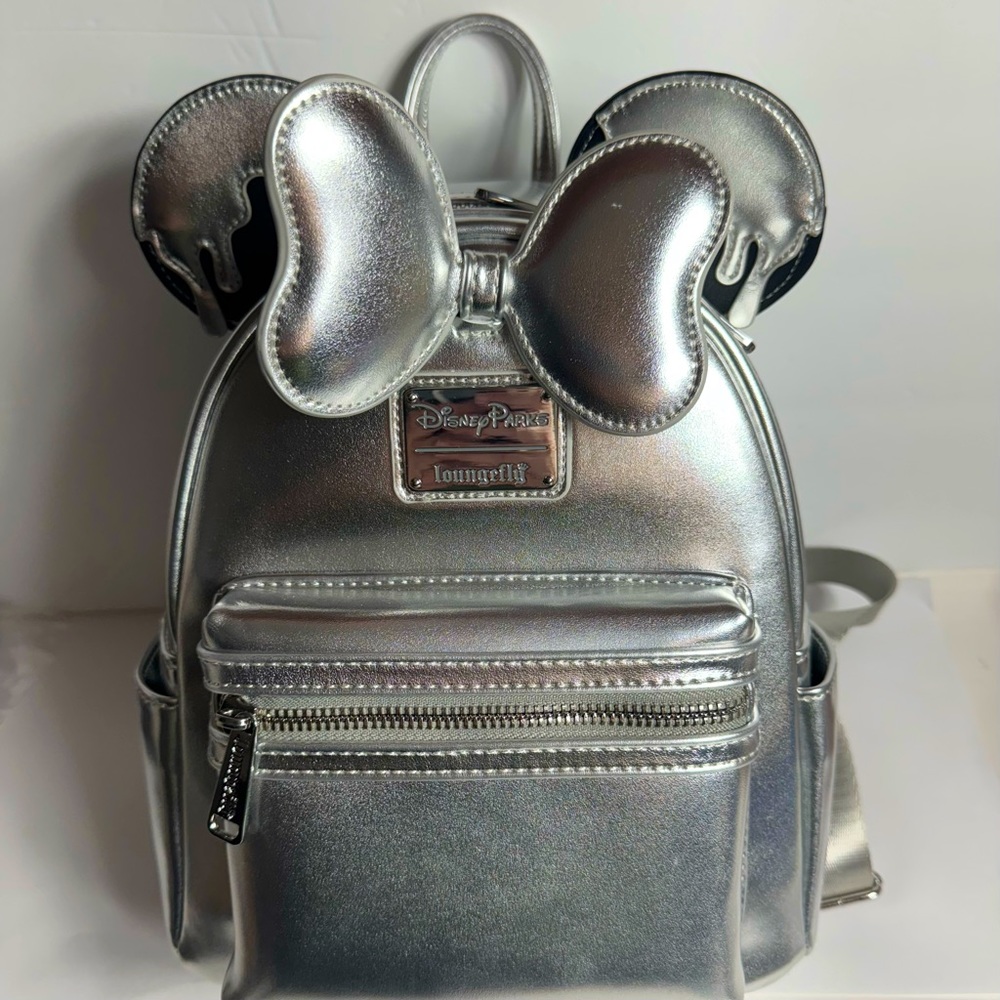 NWT. Disney Loungefly Backpack -  Disney100
gorgeous shiny silver tone